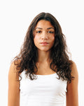 Before photo of long curly dark hair shown ahead of using Decibel thickening shampoo.