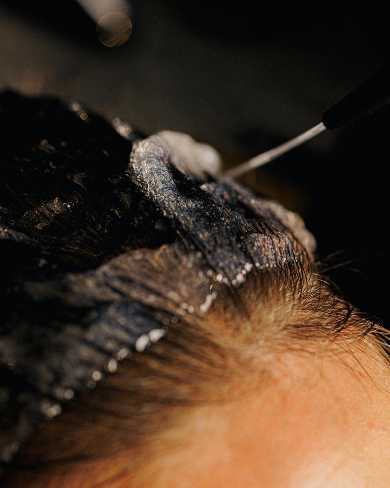 Step 3: Applying Decibel Hypertrophy thickening and volumizing treatment to wet hair at the scalp.