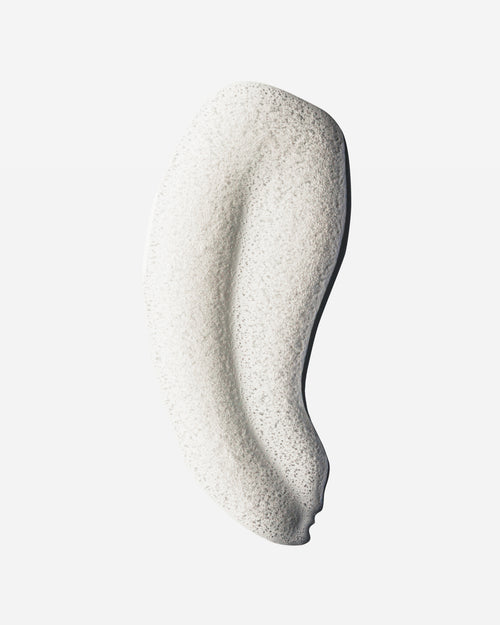Foamy white shampoo swatch with airy bubble texture, showing the lather of Decibel thickening shampoo.