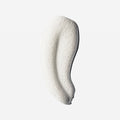 Foamy white shampoo swatch with airy bubble texture, showing the lather of Decibel thickening shampoo.