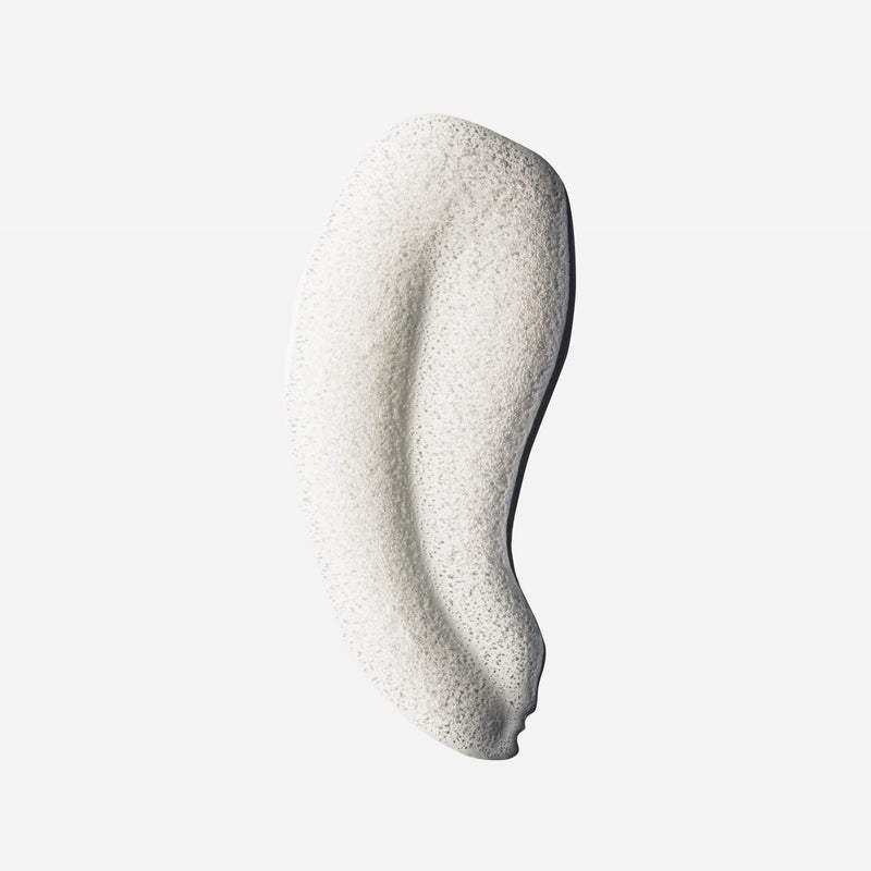 Foamy white shampoo swatch with airy bubble texture, showing the lather of Decibel thickening shampoo.